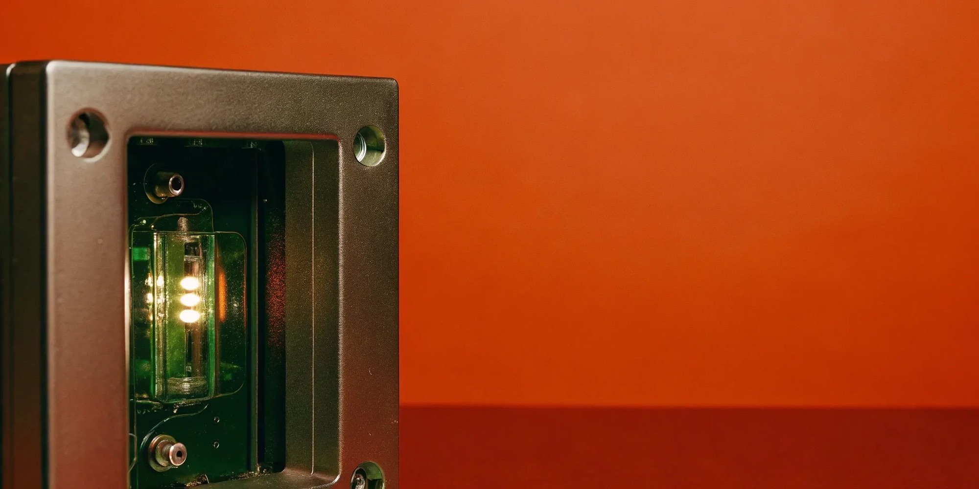 Electronic device with circuit board and glowing lights, demonstrating enclosure design.