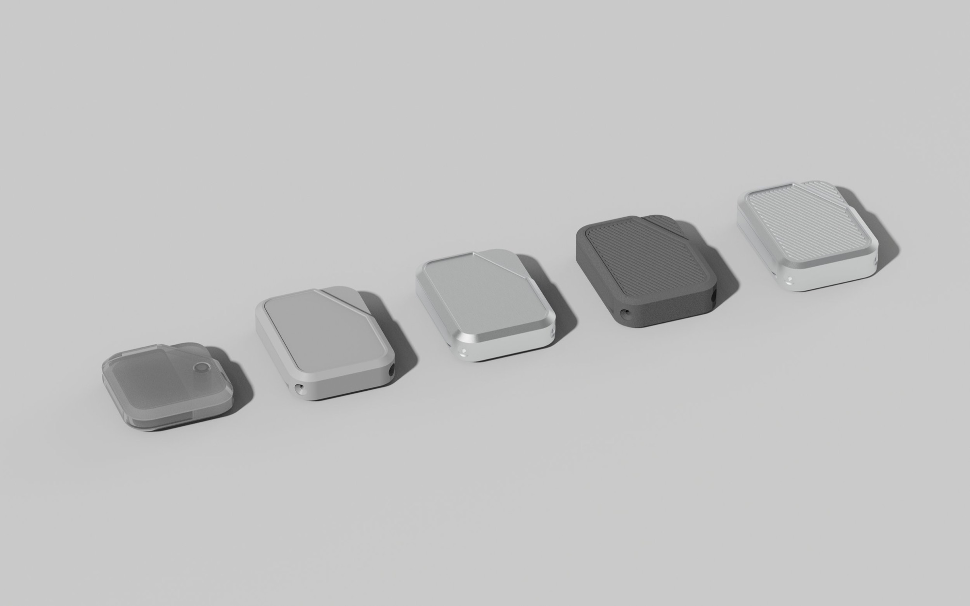 Series of five square electronic devices or gadgets in different shades of gray and black, aligned diagonally on a plain light gray background.