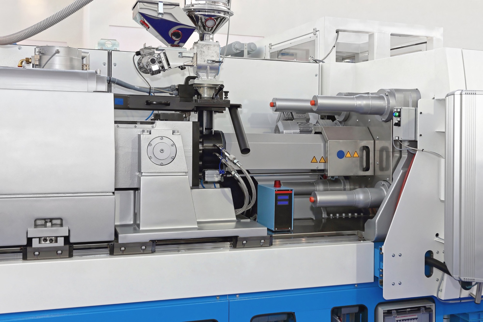 Close-up of a high-tech industrial precision manufacturing machine in a clean, well-lit facility.