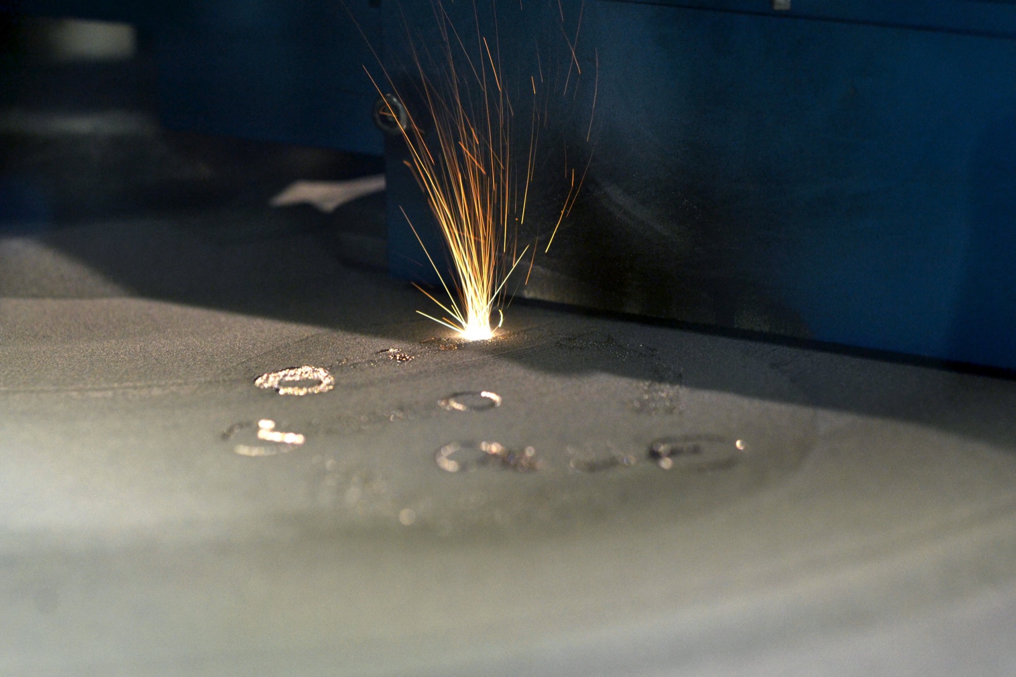 A welding process producing sparks on a metallic surface.